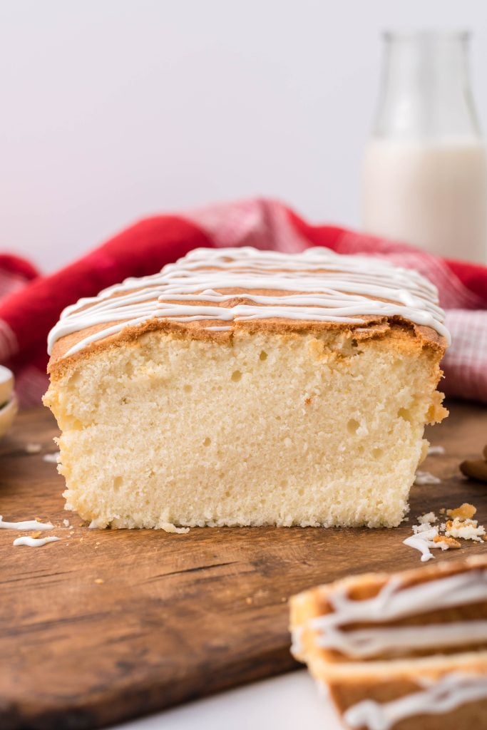eggnog pound cake being shown sliced on a wooden cutting board
