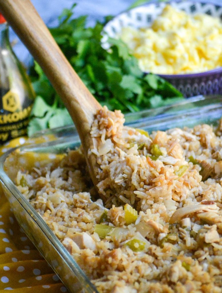 oven baked chicken fried rice in a clear glass pyrex baking dish