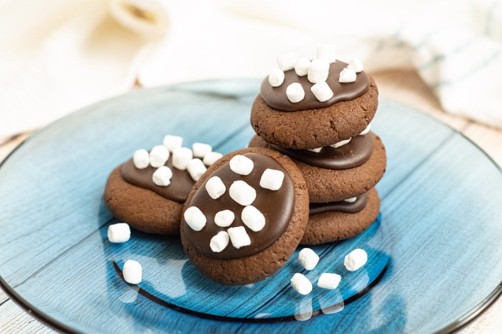 hot chocolate cookies stacked on a blue plate