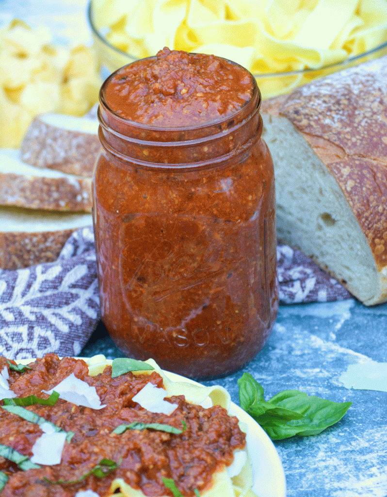 slow cooked bolognese sauce shown in a glass jar