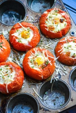 egg stuffed baked tomatoes shown in a muffin tin pan