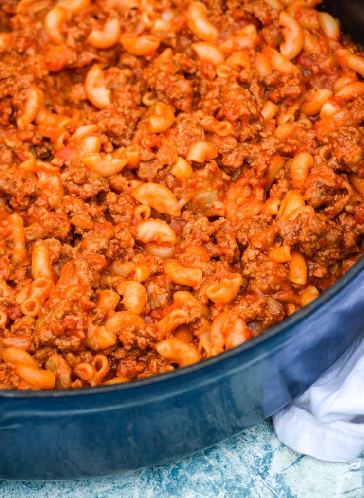 homemade beefaroni shown in a blue enameled cast iron pot