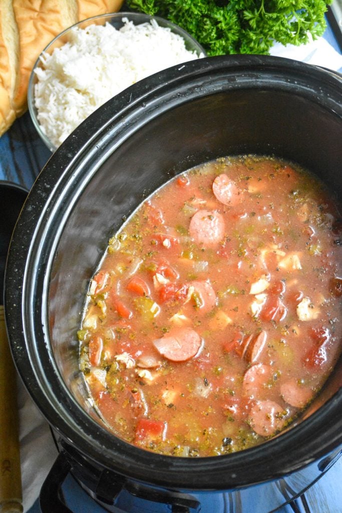 slow cooker jambalaya stew shown in the black bowl of a crockpot