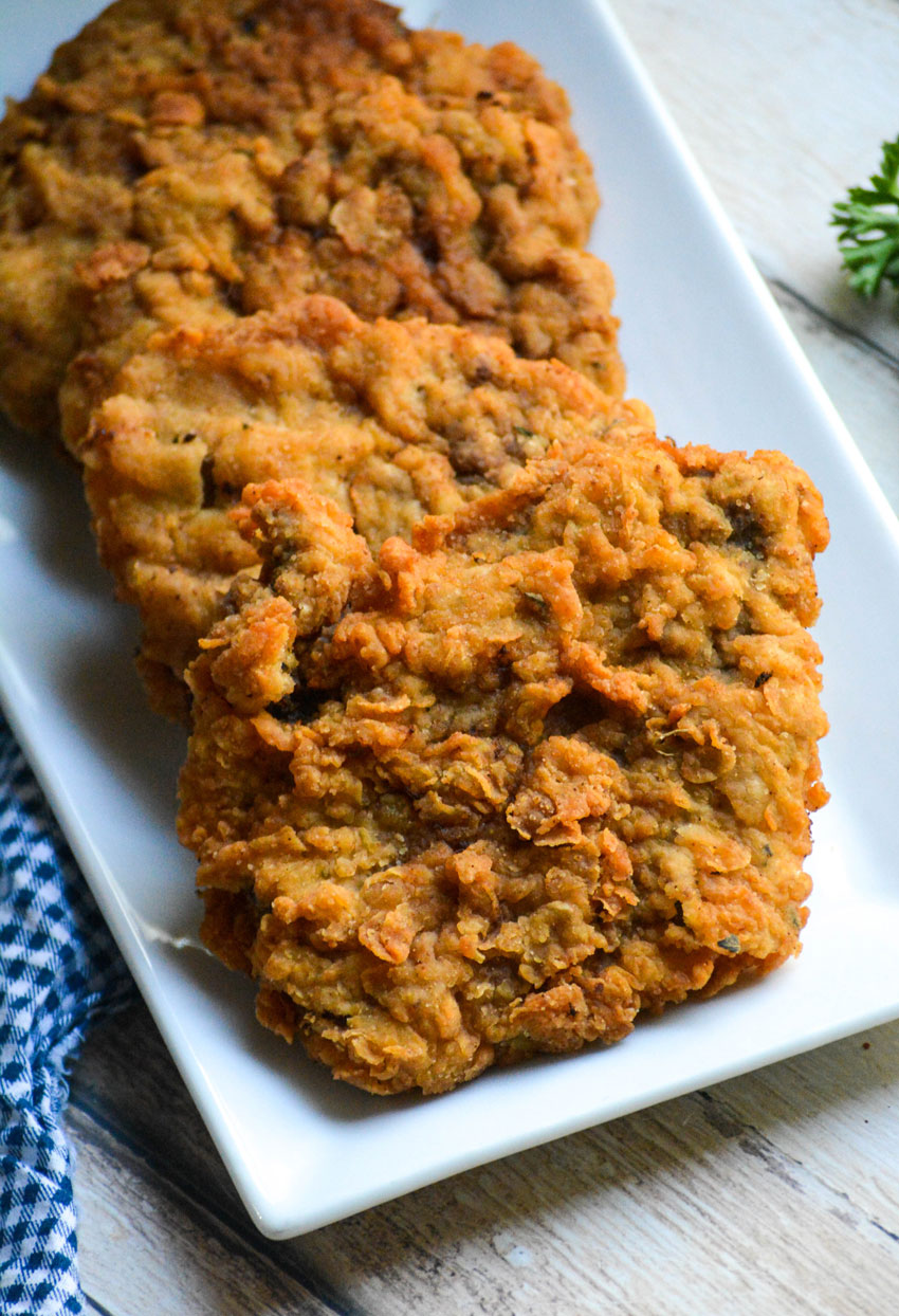 country fried steak with gravy shown on a white serving platter