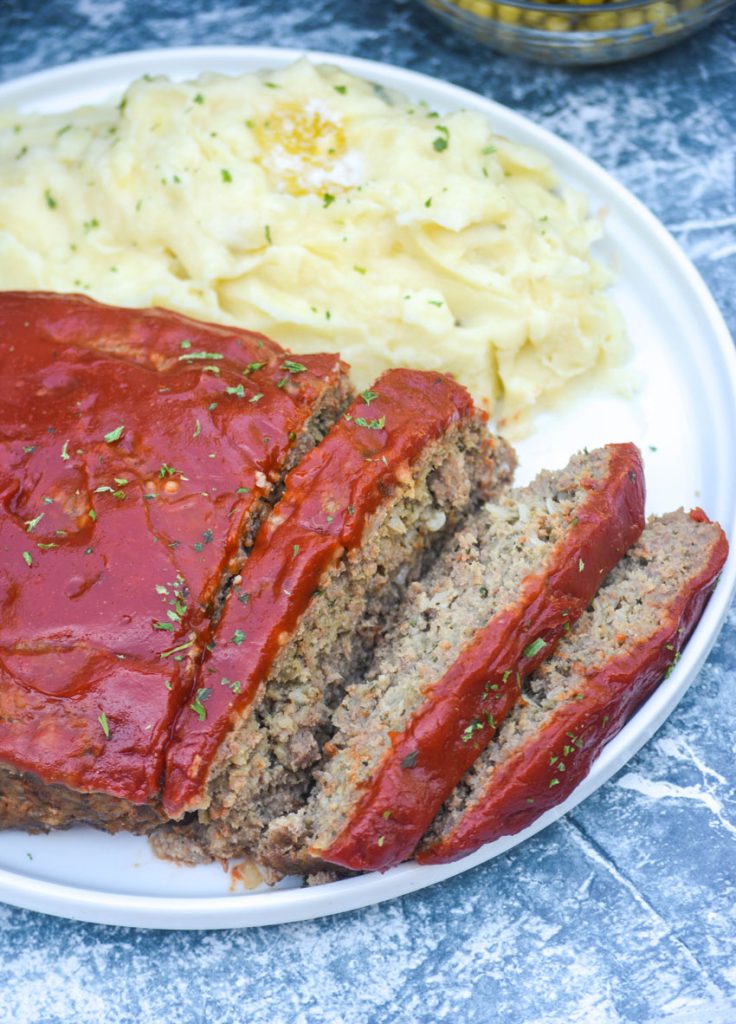 Instant pot meatloaf served on a white plate and sliced