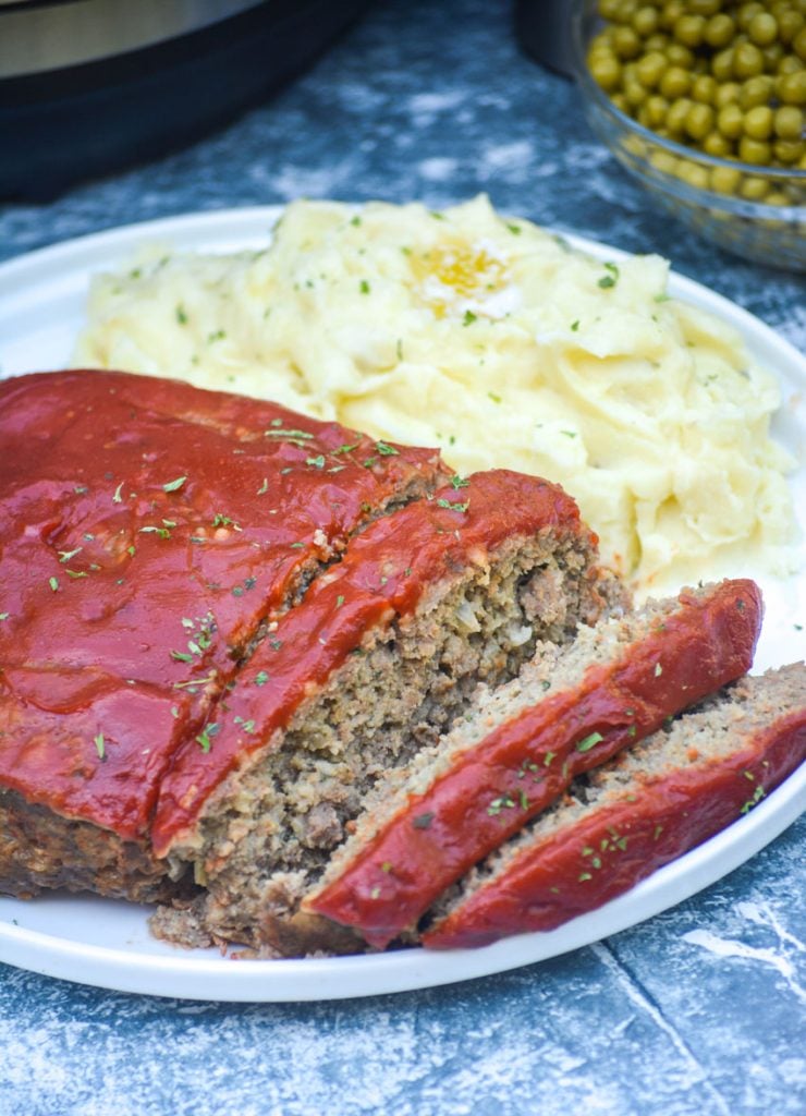 Instant pot meatloaf served on a white plate and sliced