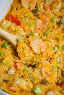 shrimp & rice casserole with a wooden spoon shown serving