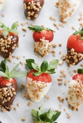 fresh toffee and chocolate covered strawberries arranged on a sheet of parchment paper