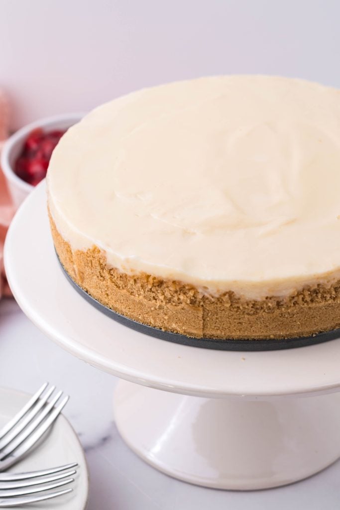 a cremora tart shown on a white pedestal cake stand