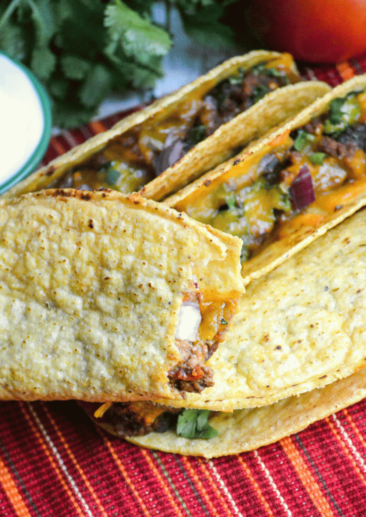 a bite shown taken out of an oven baked taco