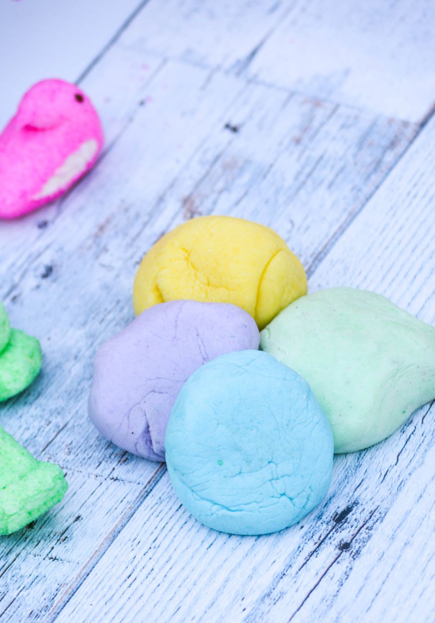 4 different colored balls of Peeps playdough shown together
