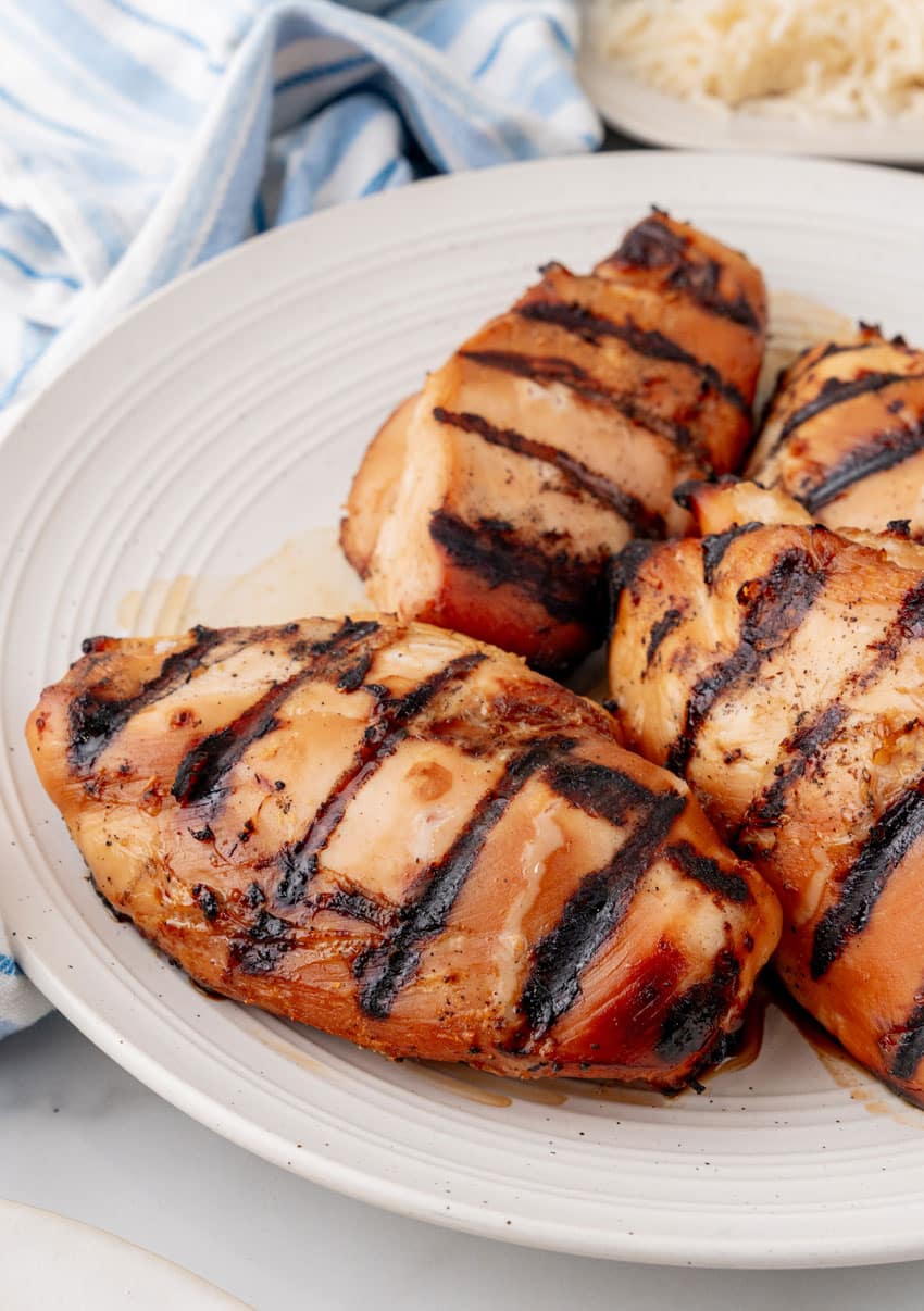 grilled teriyaki chicken breasts on a white serving plate