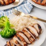 a grilled teriyaki chicken breast with white rice and steamed broccoli on a white plate