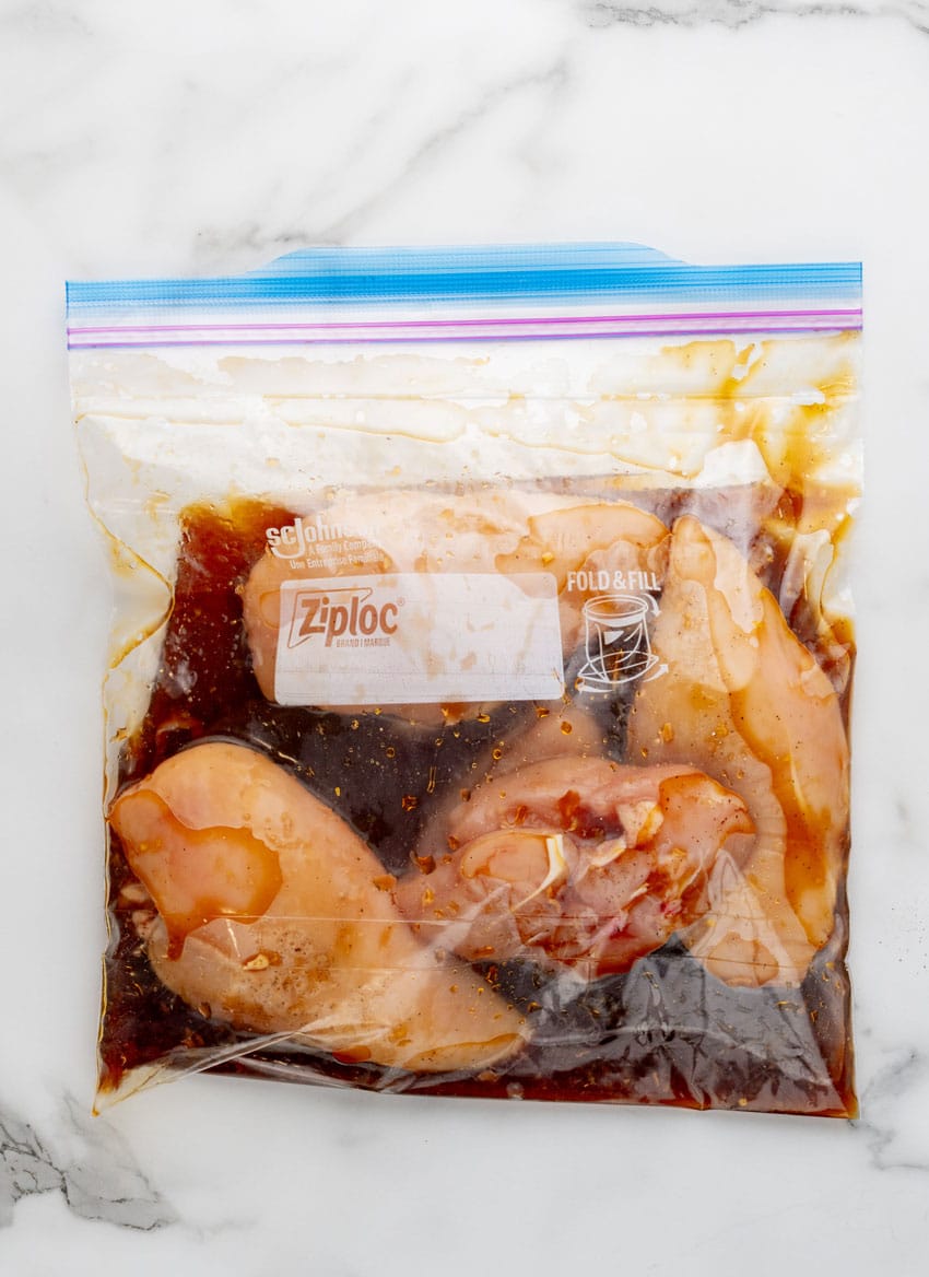 chicken breasts marinating in a large ziplocking bag