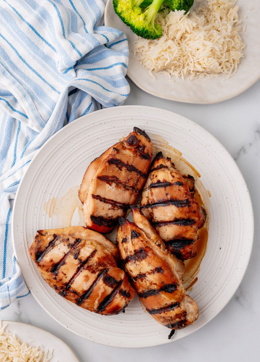 grilled teriyaki chicken breasts on a white serving plate
