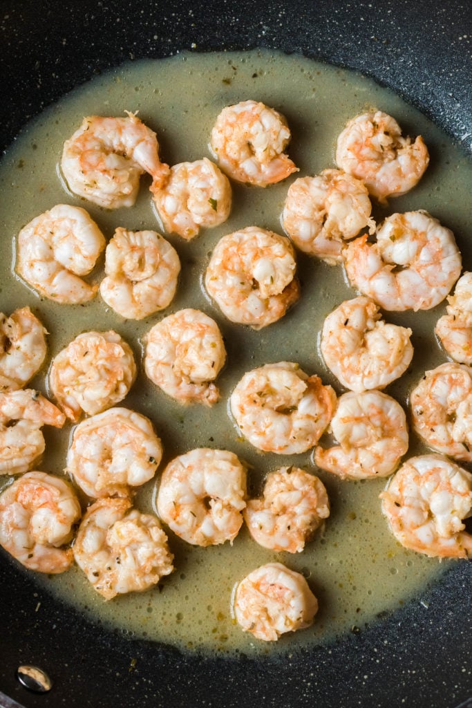 zesty fiesta lime shrimp shown cooked in a skillet with butter