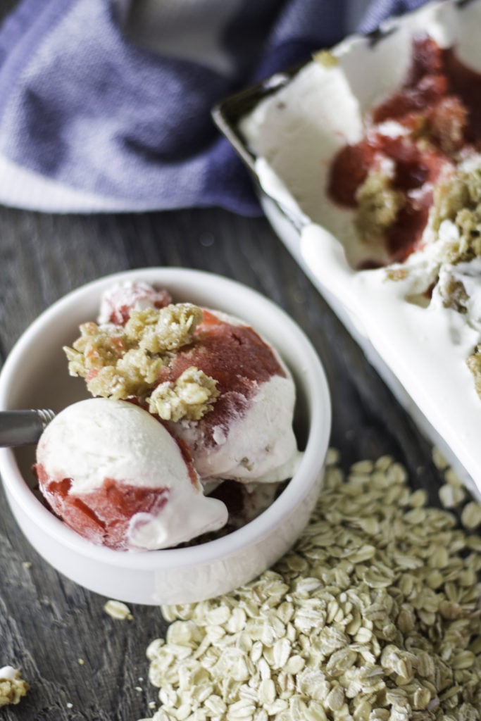 no churn cherry cobbler ice cream shown in a white bowl topped with streusel