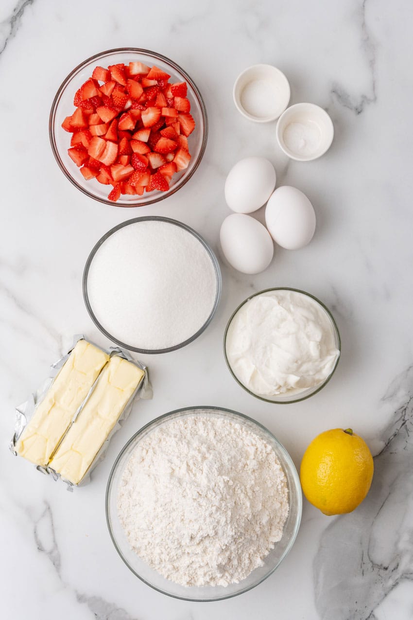 an overhead image showing the measured ingredients needed to make a glazed strawberry lemon yogurt cake