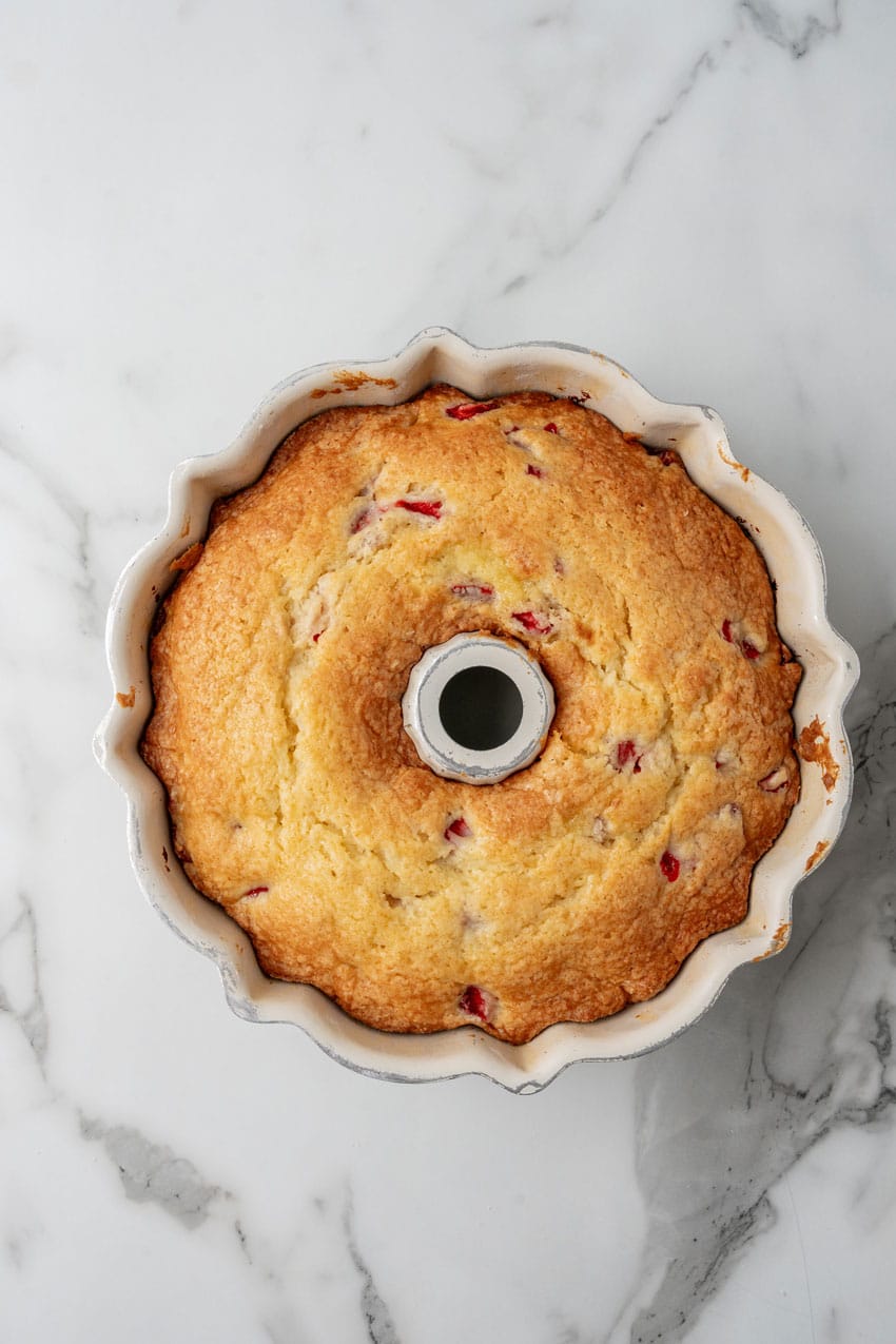 a baked strawberry lemon yogurt cake in a bundt pan