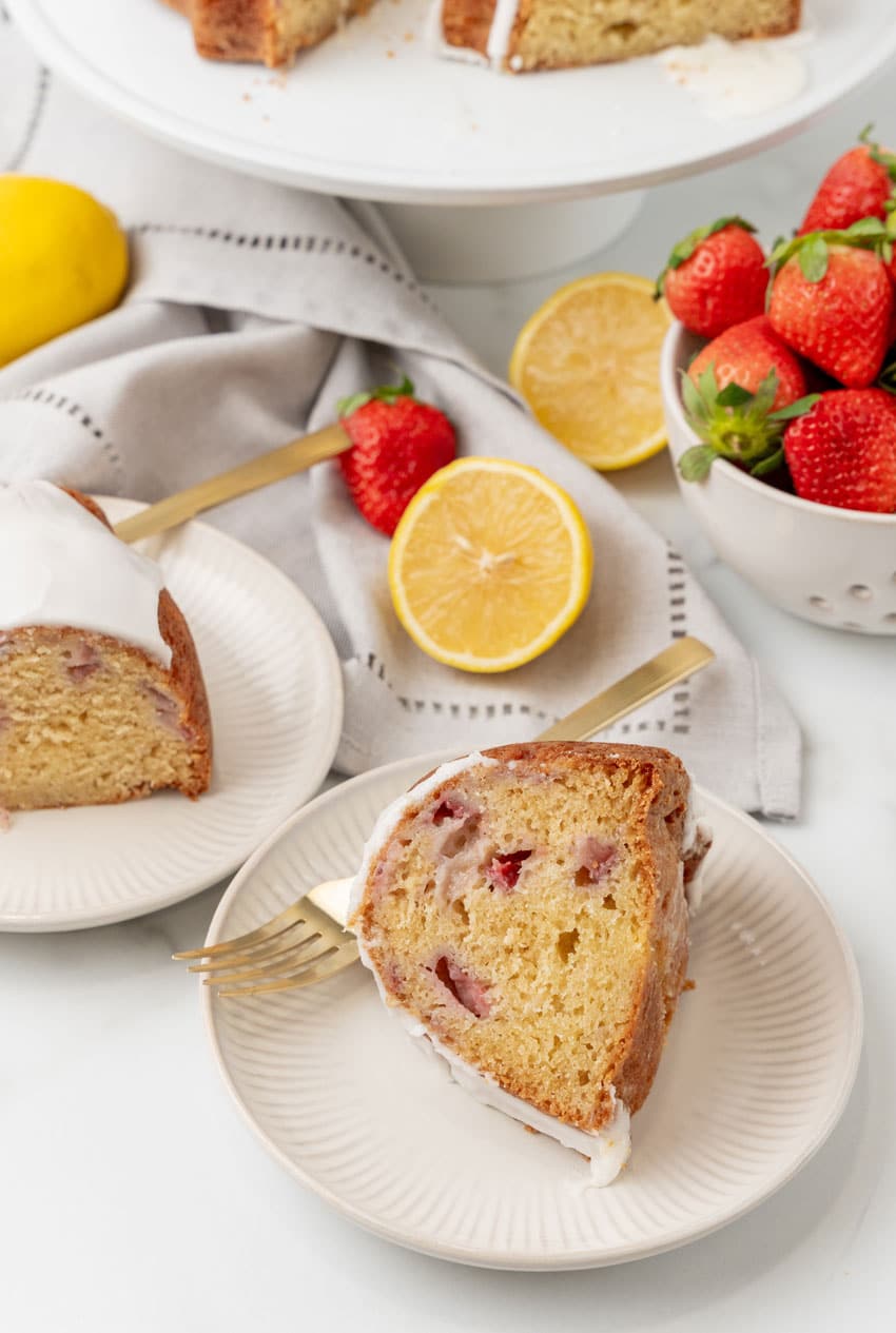 slices of strawberry lemon yogurt cake on small white dessert plates