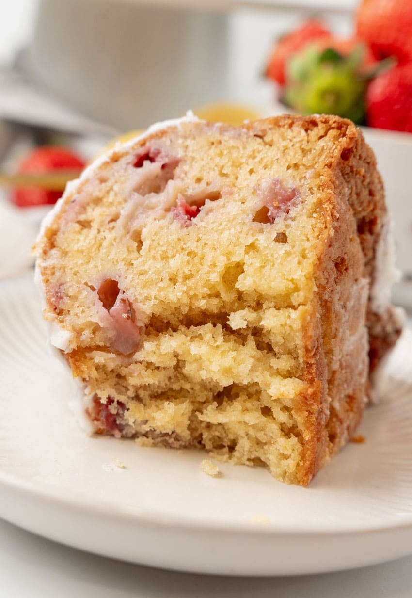 a piece of strawberry lemon yogurt cake on a small white plate