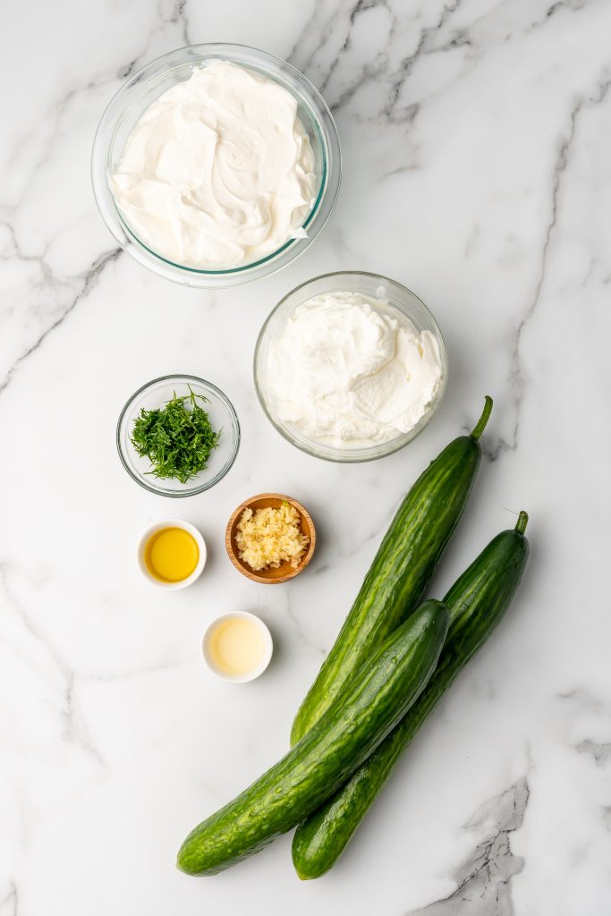 overhead image showing the measured ingredients needed to make a batch of nonna's homemade tzatziki sauce