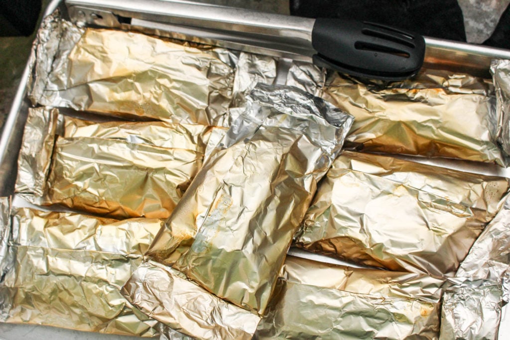 grilled chicken fajita foil packets shown on a baking pan