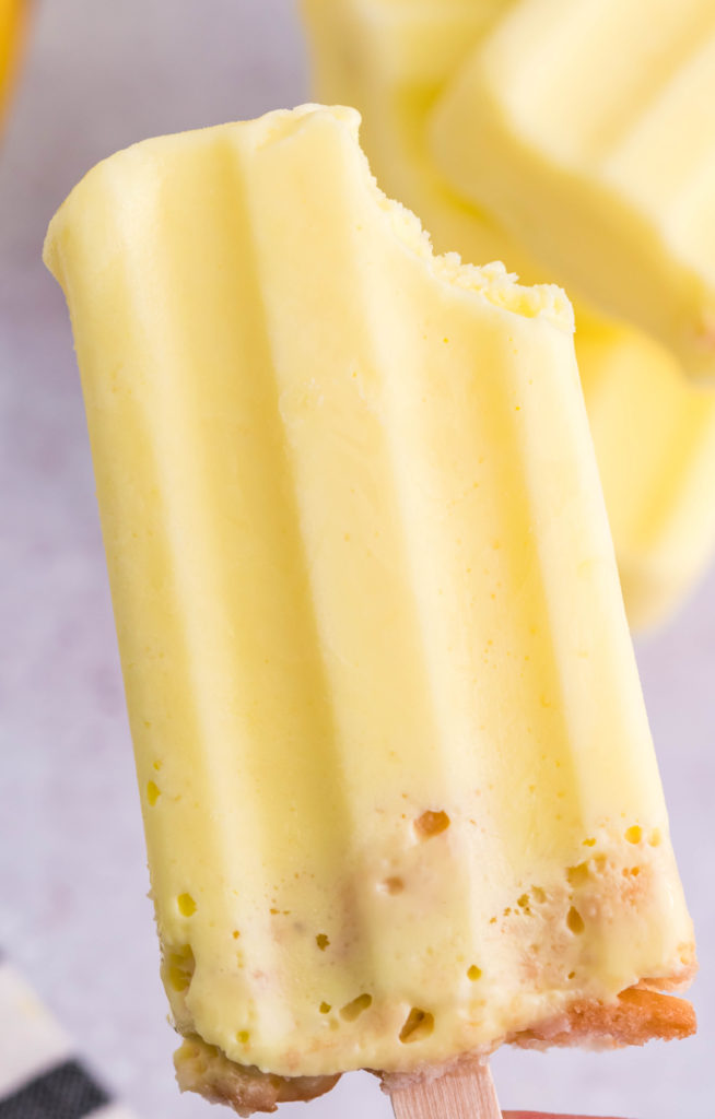 a banana pudding popsicle with a bite taken out of the top right corner
