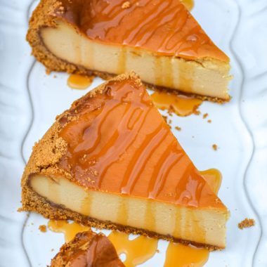 three pieces of caramel drizzled smoked cheesecake on a white platter