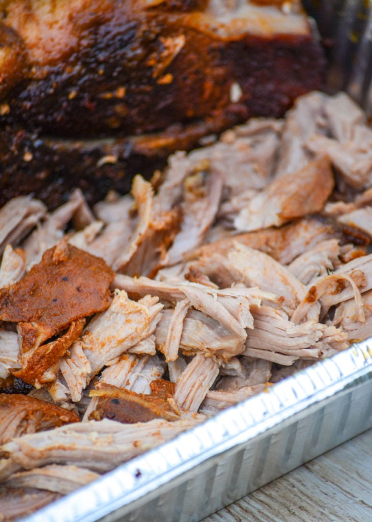 smoked pulled pork shown in an aluminum tray
