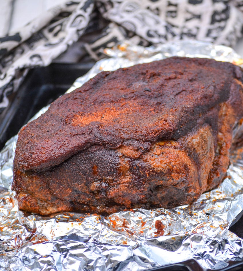 smoked pork shoulder shown on a piece of wrinkled aluminum foil
