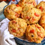tomato zucchini feta muffins in a blue wire basket lined with white cloth
