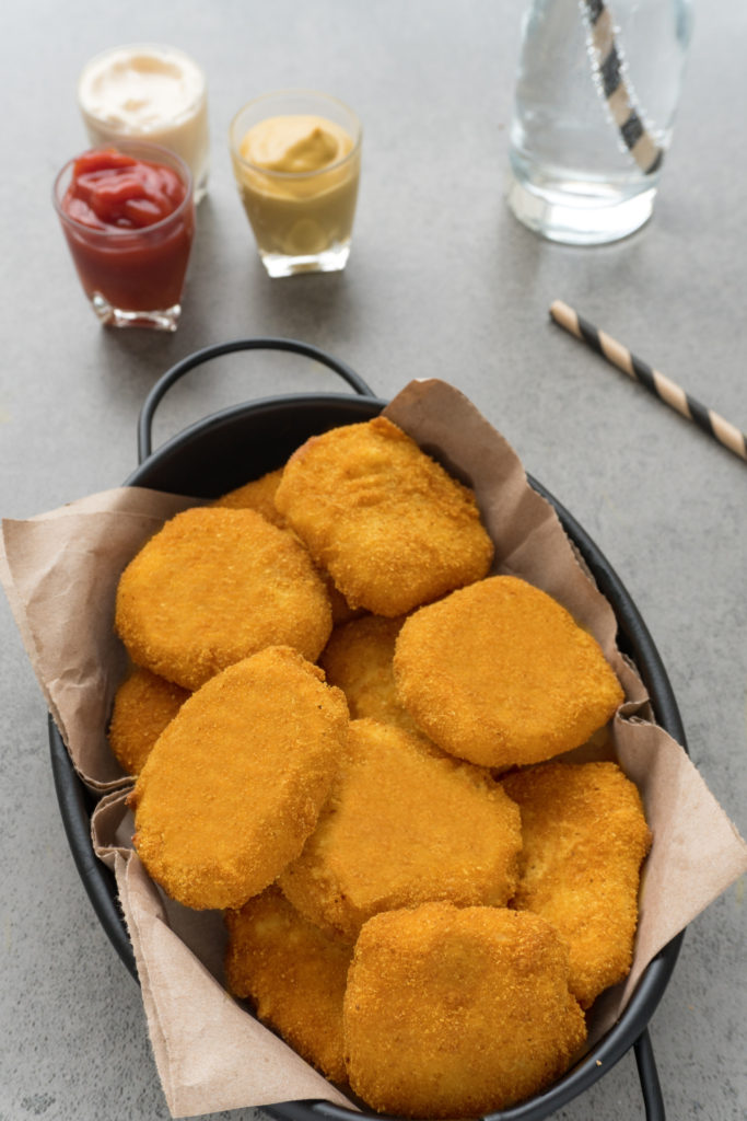 a pile of homemade nuggets on a cloth lined black dish