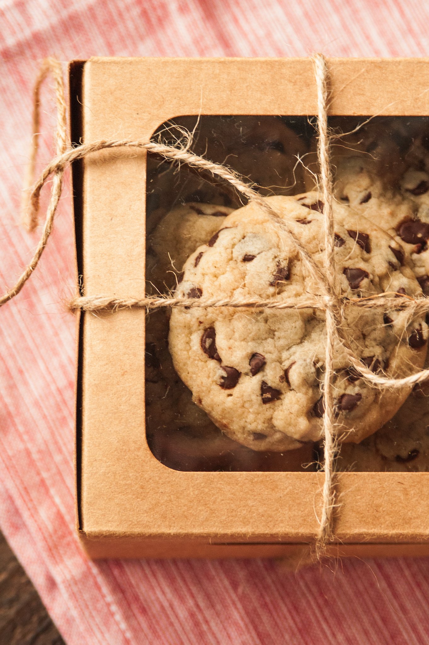 the best homemade chocolate chip cookies in a card board dessert box tied with a piece of twine