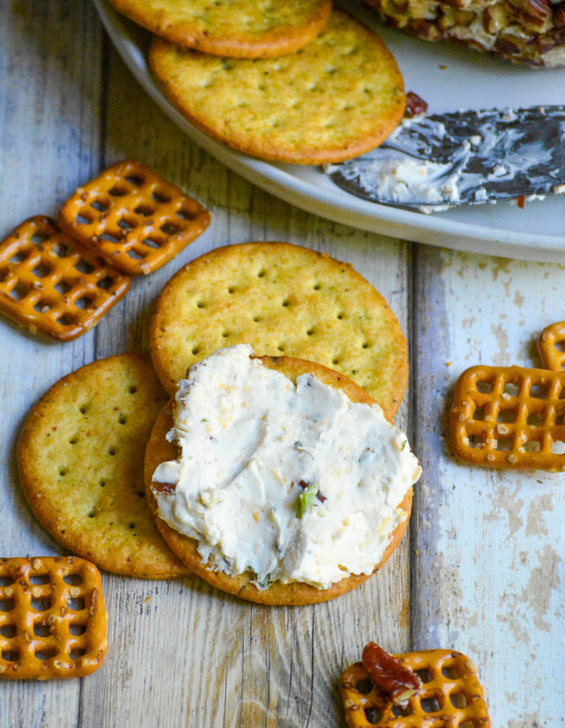a cracker on the a cracker spread with a seasoned cream cheese mixture from a savory basic cheeseball recipe