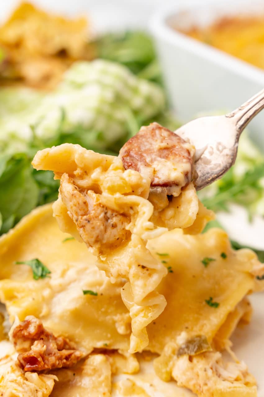 a silver fork holding up a scoop of creamy cajun lasagna