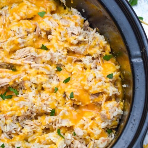 slow cooker pork and rice in a black crock