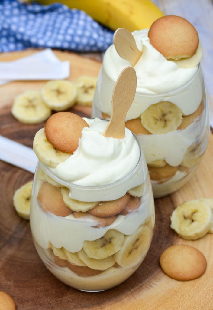 Magnolia bakery banana pudding recipe layered in glasses topped with sliced bananas and vanilla wafers