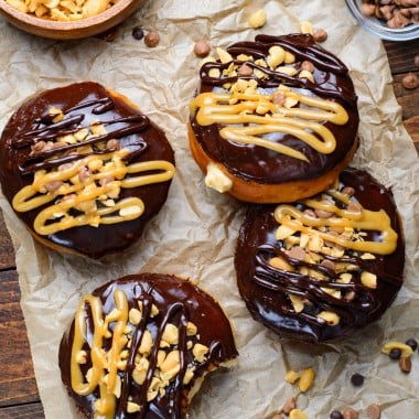 peanut butter stuffed reese's donuts on a crumpled sheet of brown parchment paper