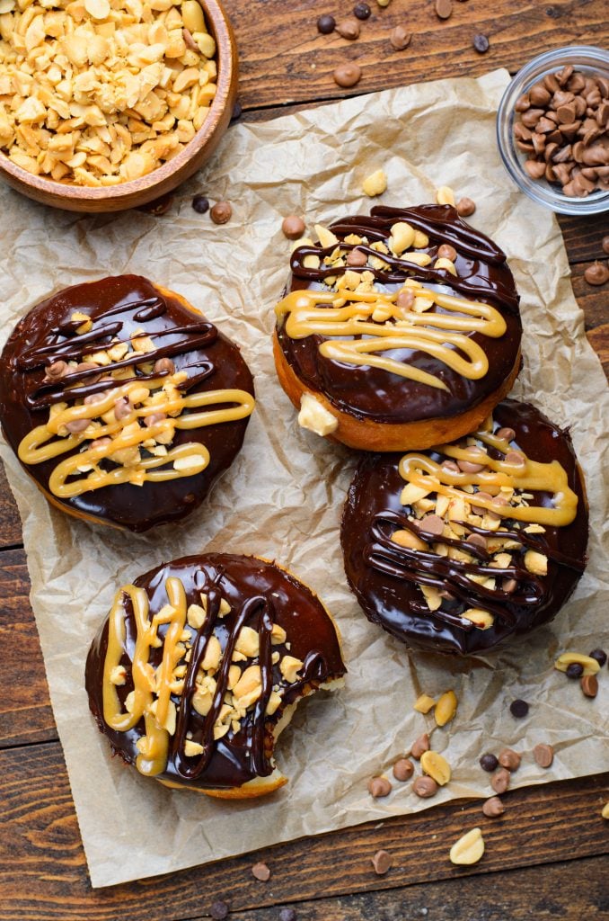 peanut butter stuffed reese's donuts on a crumpled sheet of brown parchment paper