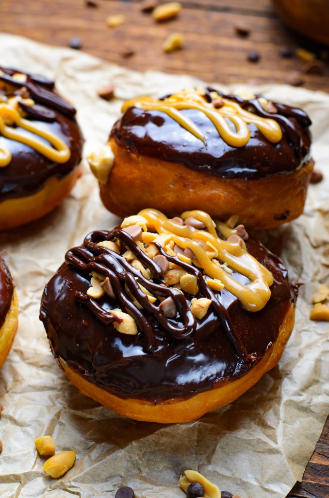 reese's stuffed donuts on a crumpled sheet of brown parchment paper
