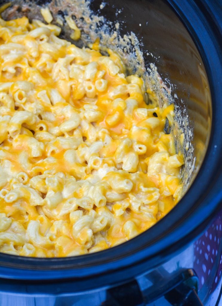 slow cooker macaroni & cheese in the black bowl of a crockpot