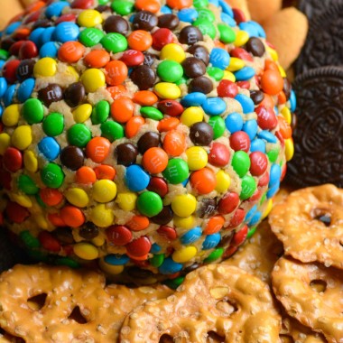 monster cookie cheeseball surrounded by cookies and pretzels