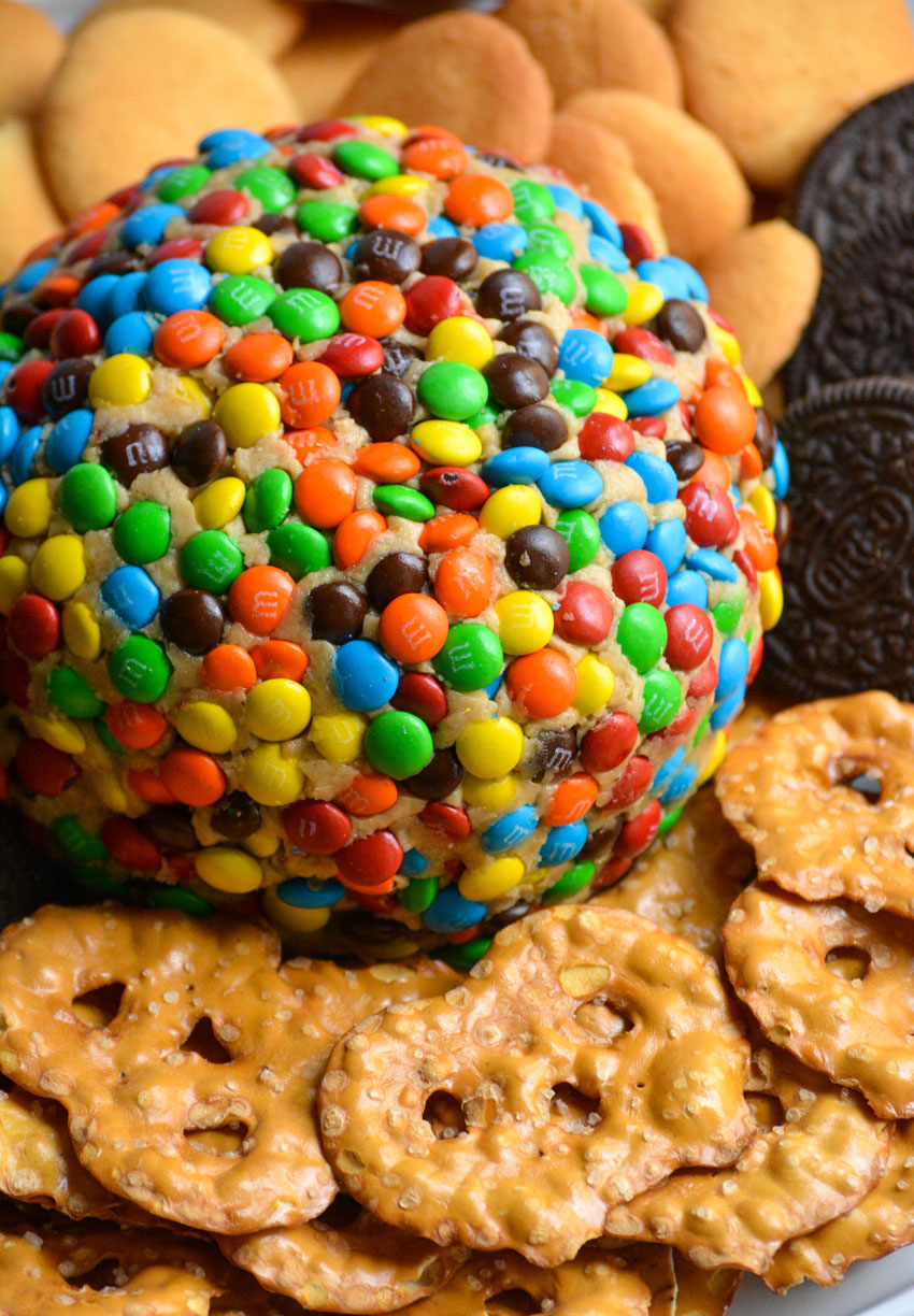 monster cookie cheeseball surrounded by cookies and pretzels 