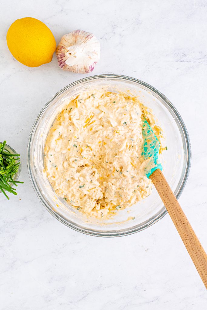 crab dip mixture in a glass mixing bowl