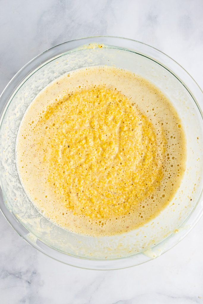 mixed yellow batter in a glass mixing bowl