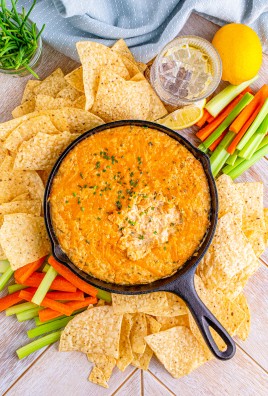 smoked crab dip in a black cast iron skillet surrounded by tortilla chips
