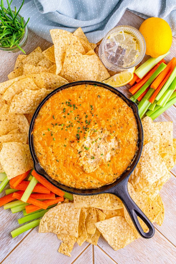 smoked crab dip in a black cast iron skillet surrounded by tortilla chips