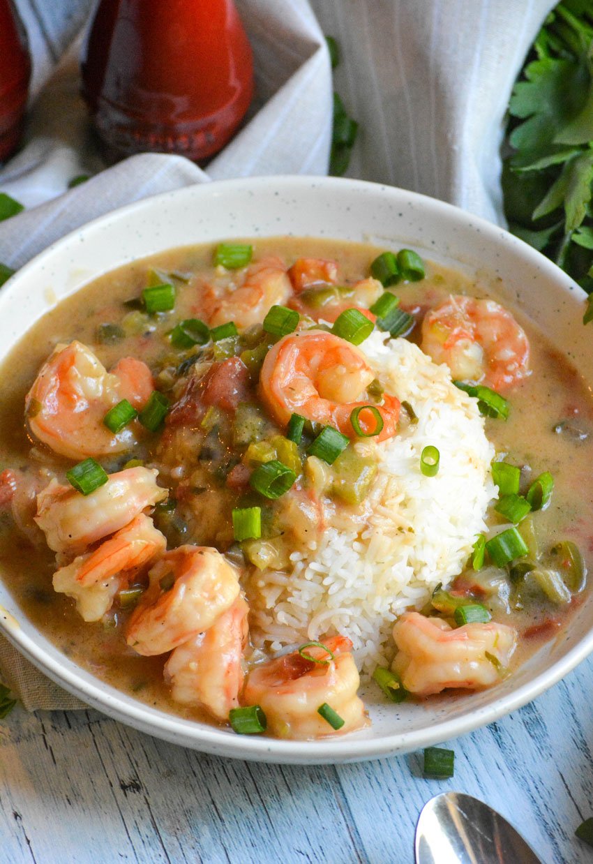 shrimp etouffee in a white bowl with rice