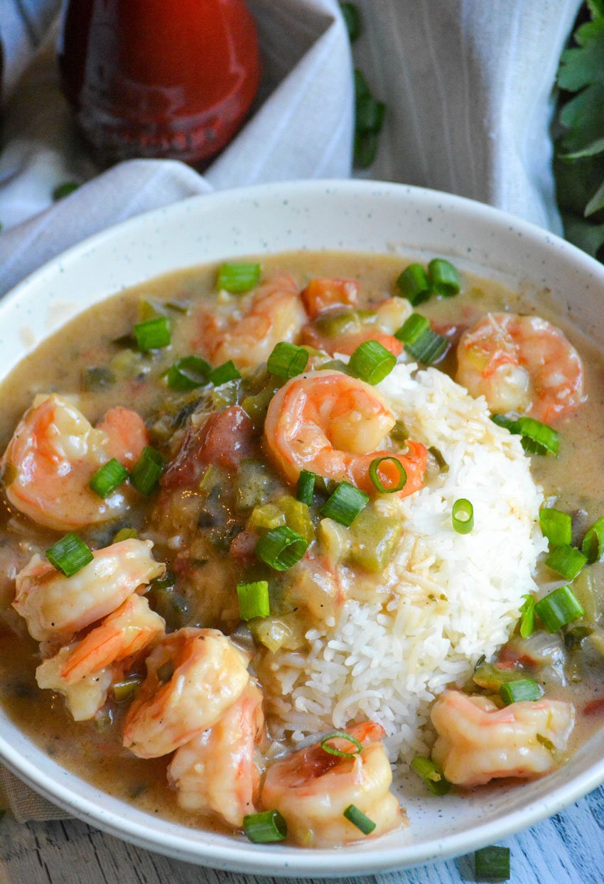 shrimp etouffee in a white bowl with rice